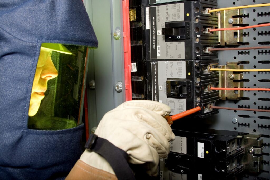 Technician wearing URIM-SPARK arc-flash protection fabric garment